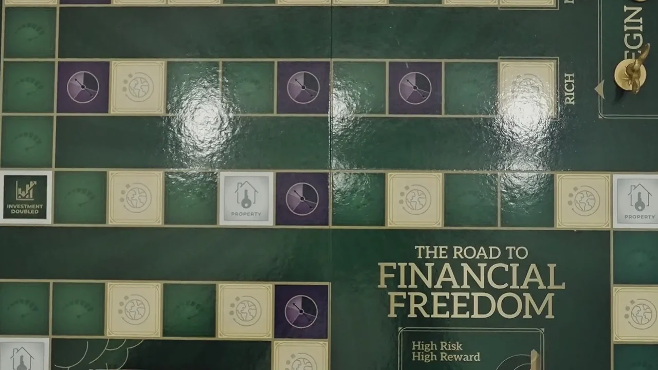 KTAL NBC 6 segment preview frame showing The Road to Financial Freedom game board