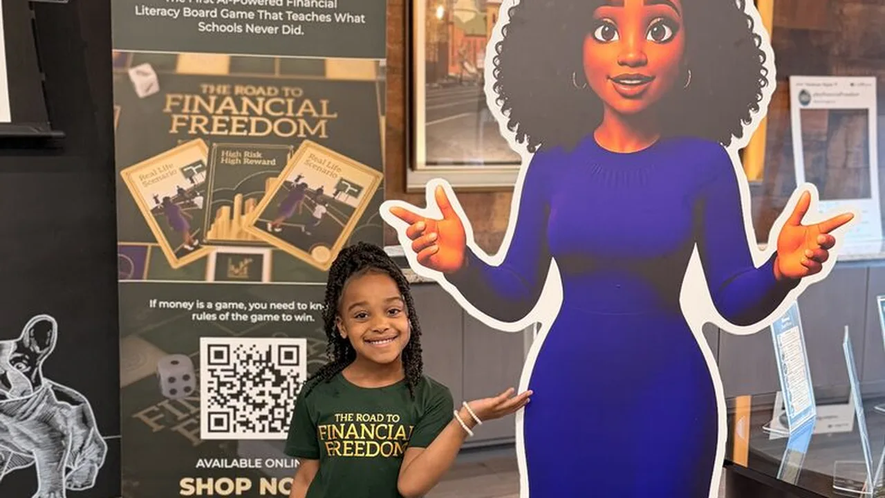 A young girl standing beside the Harriet character standee at a Road to Financial Freedom community event